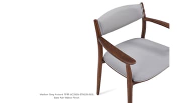 A side profile view of a modern armchair with a wooden frame and upholstered seat and backrest. The frame is constructed from solid ash with a walnut finish. The upholstery appears to be a light grey nubuck fabric. — 3D model