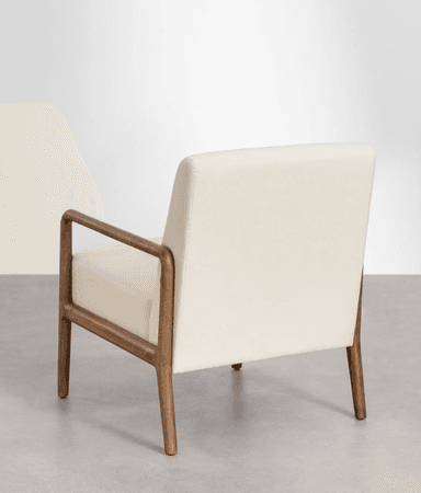 A close-up view of the base of an armchair, showing the junction of a cream-colored upholstered seat and a wooden frame. The wooden elements appear to be made of a light to medium-toned wood with visible grain, exhibiting a smooth, finished surface. The upholstery is subtly textured and features clean stitching lines. The overall design suggests a modern or mid-century modern aesthetic. — 3D model