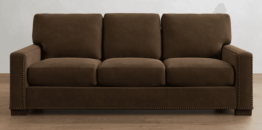 A three-seater sofa upholstered in a dark brown fabric with a suede-like texture. It features square armrests and back cushions, with a base that is also upholstered and accented with decorative nailhead trim along the front and sides. The sofa is supported by short, block-style legs that are not clearly visible. The overall style appears to be transitional or modern-classic. — 3D model
