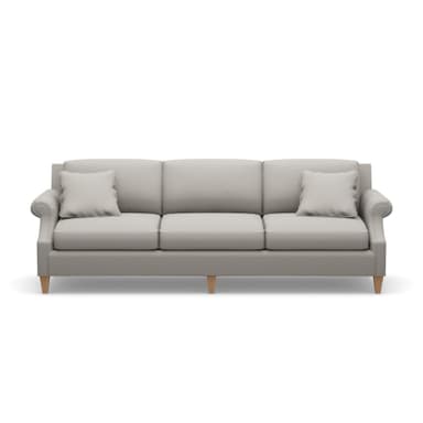 A three-seater sofa with a light gray upholstered body. It features plush seat cushions and back cushions, with a decorative rolled armrest on the left side. Two square throw pillows in a matching light gray fabric are placed on the sofa. The sofa is supported by four short, tapered wooden legs. — 3D model