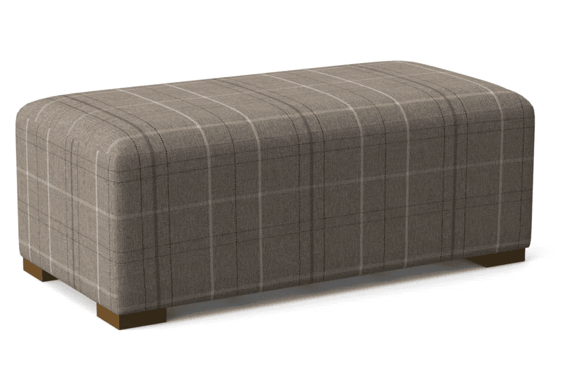 A rectangular upholstered ottoman featuring a plaid fabric pattern in shades of brown, beige, and off-white. The piece has soft, rounded edges and rests on four short, rectangular block feet. The upholstery has a textured, woven appearance. — 3D model