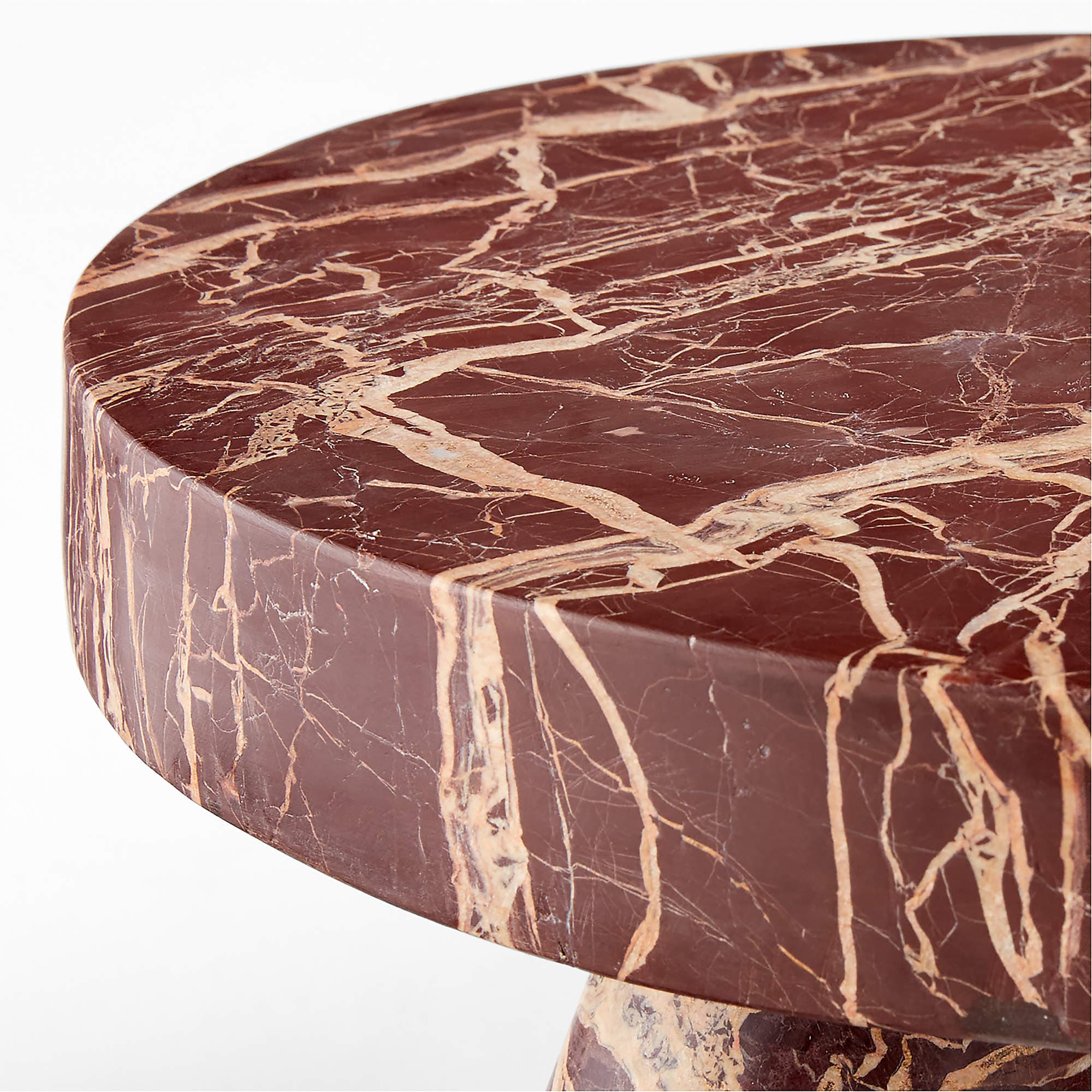A round side table with a thick, beveled edge top. The table is constructed entirely from marble, featuring a rich burgundy base color with striking white and tan veining throughout the surface and base. The visible base suggests a pedestal or column design. — 3D model