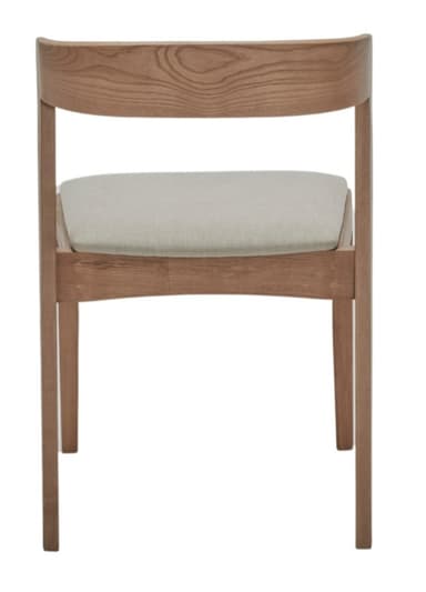 A modern dining chair constructed from light-toned wood, likely oak, featuring a curved backrest and a square seat. Both the backrest and seat are upholstered with a light, neutral-colored fabric. The chair exhibits a minimalist design with clean lines, subtly splayed rear legs, and straight front legs, offering both comfort and contemporary aesthetic appeal. — 3D model