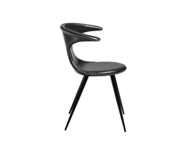A modern black chair featuring a uniquely sculptural seat and backrest upholstered in what appears to be leather or faux leather with prominent contrasting white stitching. The backrest flares out at the top and narrows significantly at the waist before widening again for the seat. It is supported by four slender, angled black metal legs. — 3D model