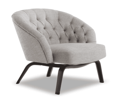 A modern armchair with a rounded, tufted backrest and a comfortably padded seat. The chair features a low profile and is supported by dark, slender legs with a curved design. The upholstery has a textured appearance. — 3D model