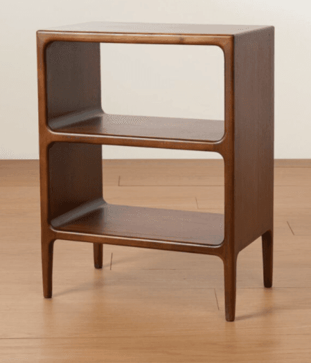 A wooden end table with a minimalist design. It features two open shelves and a smooth, curved frame. The table stands on four tapered legs. — 3D model