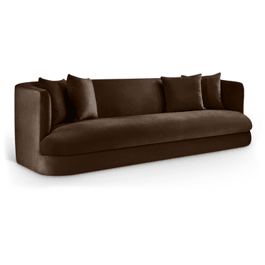 A plush, deep brown sofa with a streamlined, modern design. It features curved armrests that blend seamlessly into the backrest, and a rounded base. Two square throw pillows in a matching fabric are placed on the sofa. The upholstery appears to be a soft velvet or similar textured fabric. — 3D model