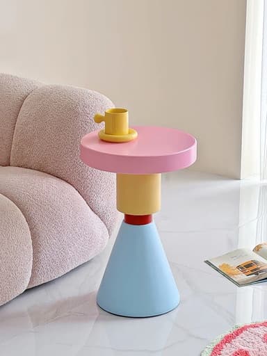 A postmodern-style accent table featuring a distinctive stacked geometric design and a vibrant, multi-colored palette. It has a round pink top, a short yellow cylindrical segment, a small red disc, and a light blue conical base, all arranged vertically. — 3D model
