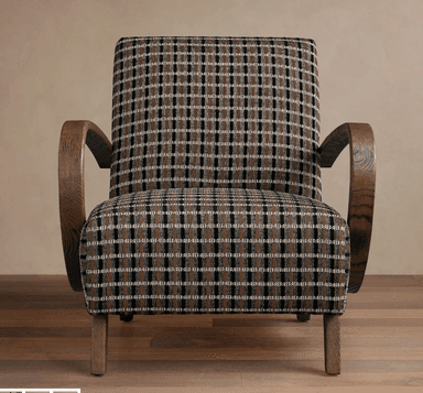 An upholstered armchair featuring a distinctive plaid pattern in dark brown, black, and cream, set against dark stained wooden arms and tapered legs. The design combines a classic aesthetic with modern lines, suitable for various interior settings. The wooden armrests exhibit a smooth, curved shape, providing a comfortable resting place. — 3D model