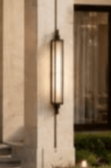 A tall, rectangular wall-mounted light fixture, featuring a dark bronze-finished metal frame and a frosted light diffuser panel. The frame is accented with decorative finials at the top and bottom, giving it a traditional or gothic aesthetic. — 3D model
