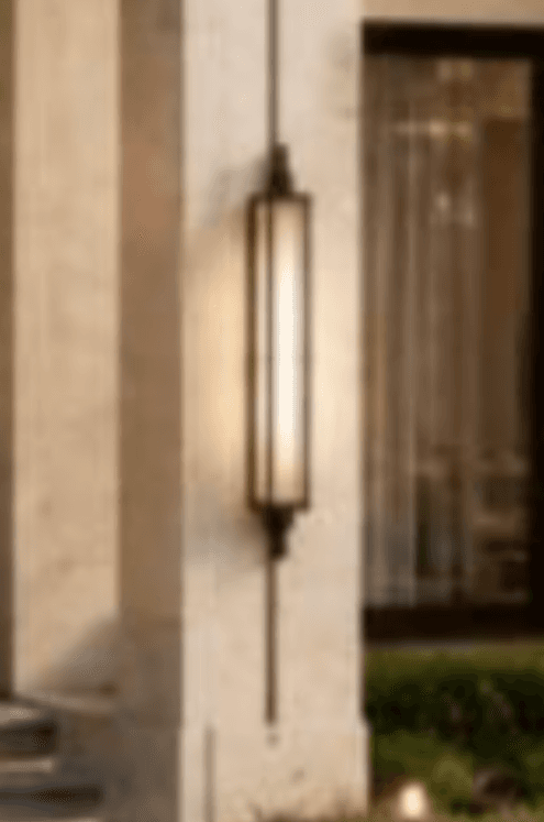 A tall, rectangular wall-mounted light fixture, featuring a dark bronze-finished metal frame and a frosted light diffuser panel. The frame is accented with decorative finials at the top and bottom, giving it a traditional or gothic aesthetic. — 3D model