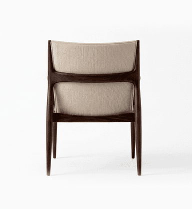 A sophisticated armchair featuring a sculpted dark wood frame with an upholstered seat and back. The design showcases elegant curves, tapered legs, and distinctive padded armrests, reflecting a Mid-Century Modern aesthetic. — 3D model