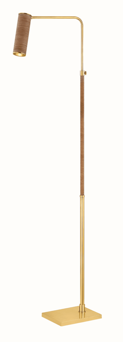 A modern floor lamp featuring a polished brass structure combined with light brown, woven natural fiber accents. It has a square base, a slender vertical pole, and a bent arm leading to a cylindrical, downward-facing lampshade. A section of the pole and the lampshade are wrapped in the textured natural material, and there's an adjustable knob on the pole, suggesting height or angle modification. — 3D model