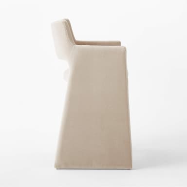 A contemporary bar stool with a sleek, minimalist design. It features a high back and armrests that are integrated into the main frame. The seat is upholstered, and the legs are substantial and straight. A metallic footrest spans between the two front legs, providing additional stability and functionality. — 3D model