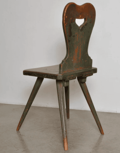 A rustic wooden chair with a distressed green painted finish, featuring a heart-shaped cutout in the backrest and splayed, tapered legs. — 3D model