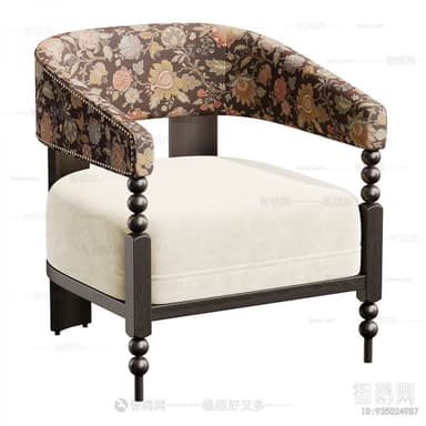 An armchair featuring a barrel-shaped back and integrated armrests upholstered in a dark, multi-colored floral fabric with brass nailhead trim. The seat cushion is upholstered in a plain, light cream fabric. The chair's frame is made of dark-stained wood, with distinctive bobbin-turned front legs and straight square rear legs. — 3D model