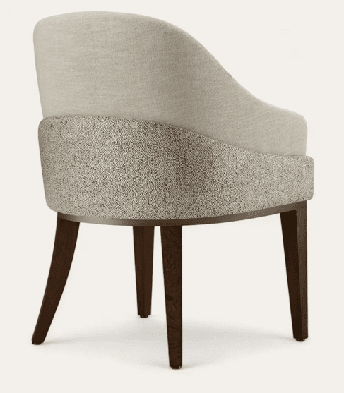 An upholstered armchair featuring a curved back and seat, with two distinct fabric textures and colors. It rests on four tapered dark wood legs, with a subtle metallic trim detailing the base of the seat. — 3D model