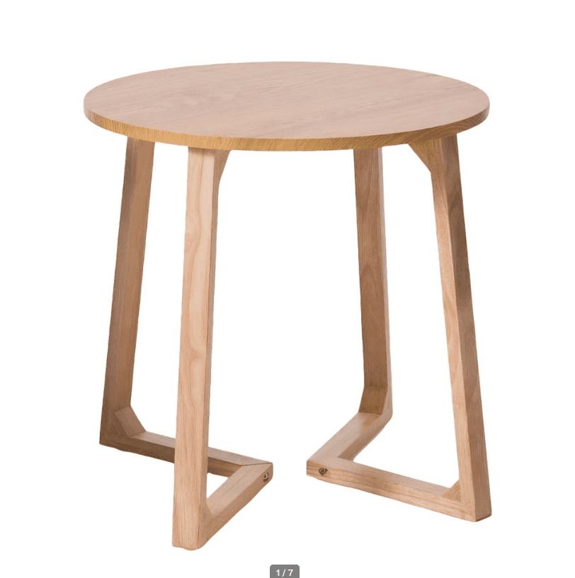 A small, round-topped side table constructed from light-toned solid wood, featuring a minimalist design with three splayed legs that form distinct U-shaped bases for stability. — 3D model