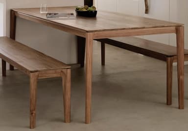 A rectangular dining table with four tapered legs. The tabletop has a visible wood grain pattern, and the legs are integrated into the frame of the tabletop. The design is minimalist and modern. — 3D model