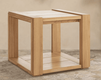 A detailed close-up shot of the corner of a two-tiered console table constructed from light-toned natural wood. The top surface features a framed design with parallel wooden planks. Directly below, a second shelf is visible, also made of parallel wooden planks, creating a functional two-tiered structure. The table leg is stout and rectangular, connected to the top and lower shelf with visible joinery, suggesting a sturdy construction. The wood exhibits a fine, consistent grain with a light, natural finish. — 3D model