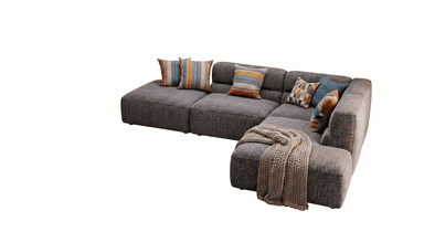A contemporary modular L-shaped sectional sofa upholstered in a textured grey fabric. It features deep seats, integrated low armrests, and is accessorized with several colorful, patterned throw pillows and a chunky knit blanket. — 3D model
