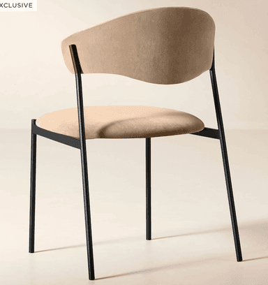 A modern dining chair featuring a black metal frame and light beige upholstered seat and a distinctively curved backrest. — 3D model