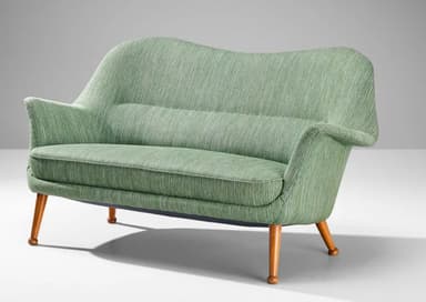 A two-seater sofa with a curvaceous backrest and armrests, upholstered in a textured green fabric. The sofa is supported by four tapered wooden legs that angle outwards. — 3D model