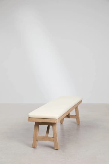 A minimalist bench with a light wood frame and a cream-colored cushioned seat. The frame features a simple, angular design with two A-frame legs connected by a horizontal support. The cushioned seat appears to be upholstered. — 3D model