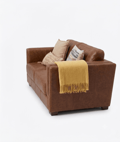 A three-seater sofa upholstered in rich, reddish-brown leather, featuring a contemporary design with clean lines and square track arms. It has a two-over-two cushion configuration with two plush seat cushions and two back cushions. The leather exhibits some natural variations and slight distressing, contributing to a lived-in aesthetic. The sofa rests on low, dark block feet and is accessorized with three decorative throw pillows and a yellow throw blanket. — 3D model