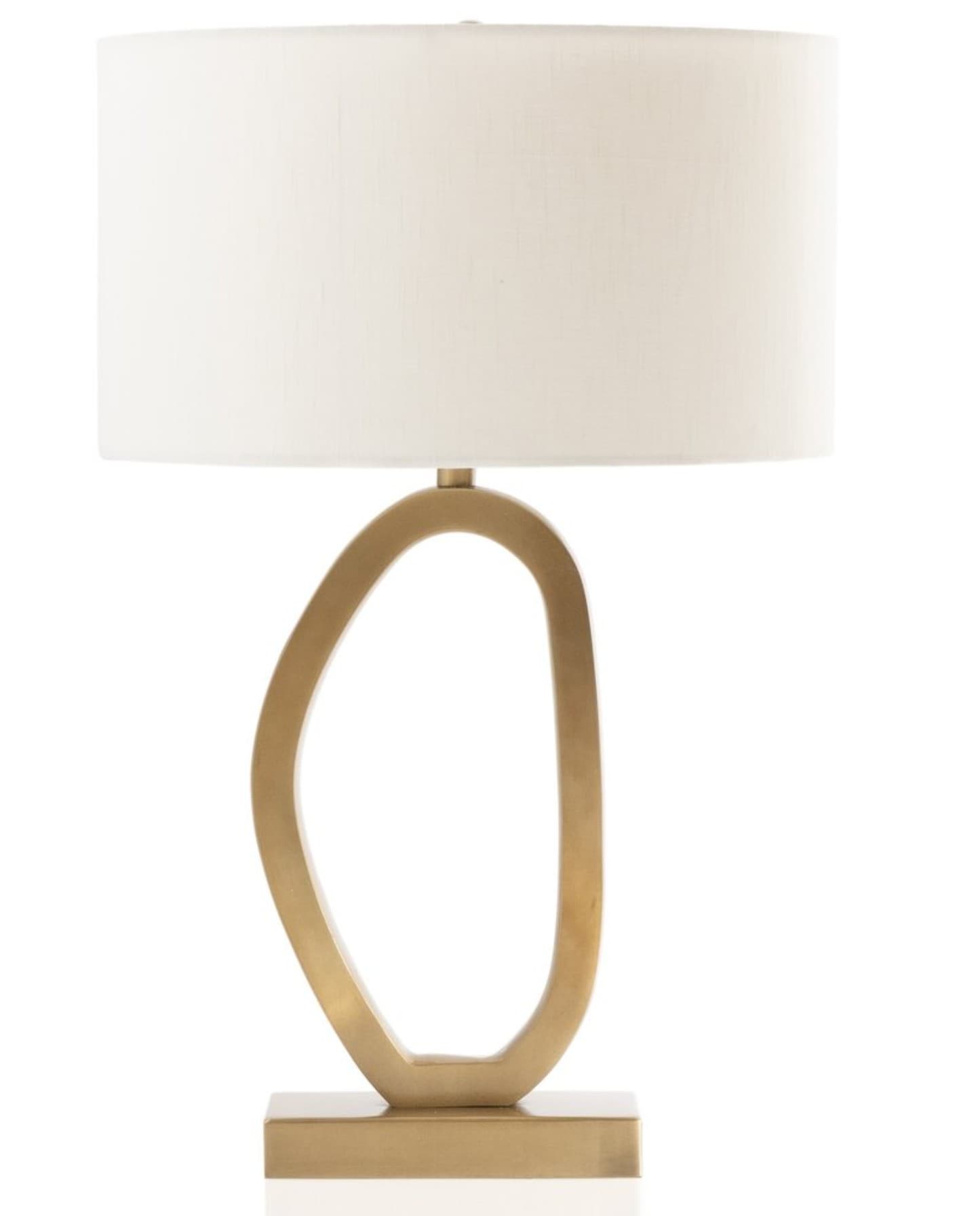 A modern table lamp featuring a sculptural, loop-shaped metal base with a brushed gold finish, supporting a simple cylindrical drum shade in a neutral cream fabric. — 3D model