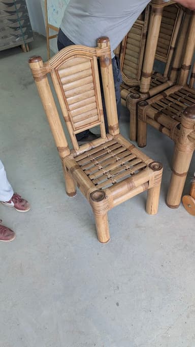 A light-colored side chair crafted from bamboo and rattan, featuring a slatted backrest and seat. The construction uses wrapped rattan details at the joints, giving it a natural and tropical aesthetic. The frame consists of cylindrical bamboo sections, and the chair has four sturdy legs. — 3D model