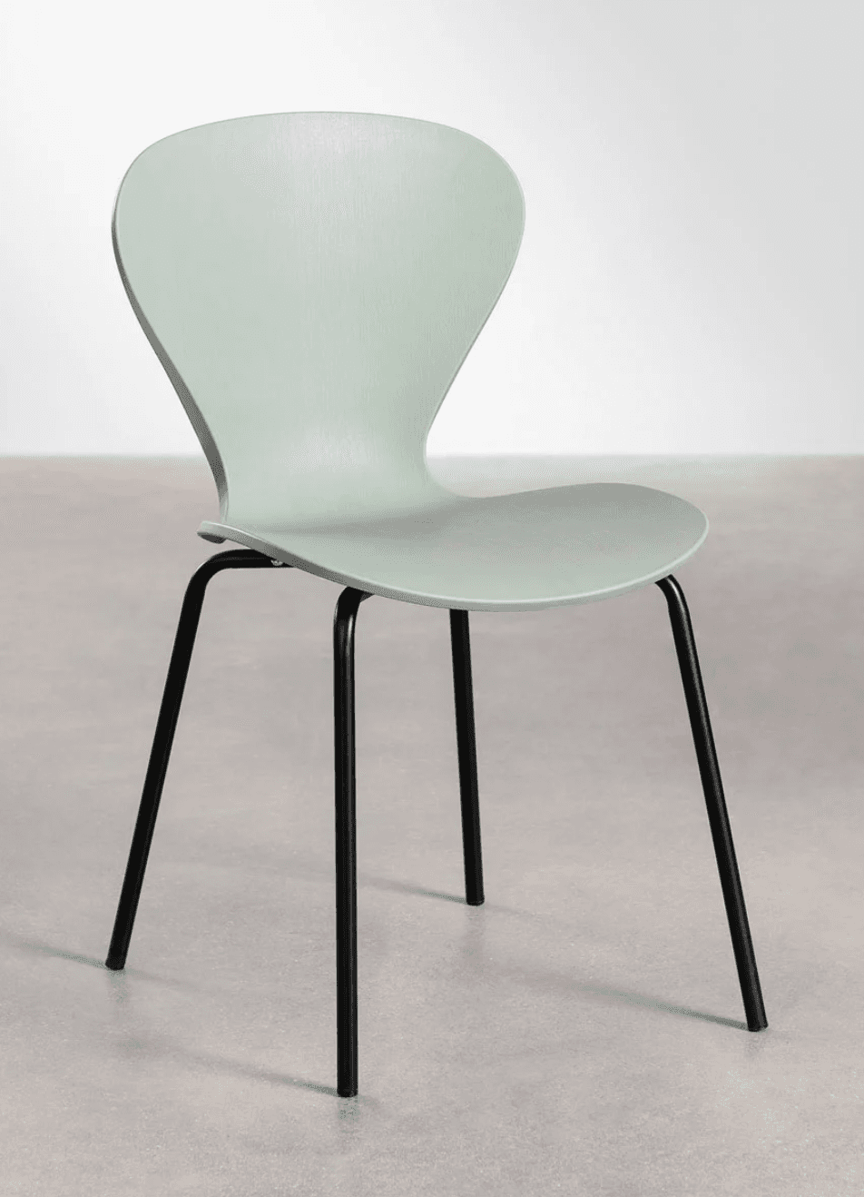 A modern dining chair with a molded shell seat and back, supported by a black metal four-leg base. The seat and back are a single, continuous piece with a subtle curvature for ergonomics. The base consists of four slender, straight legs that splay slightly outwards. — 3D model
