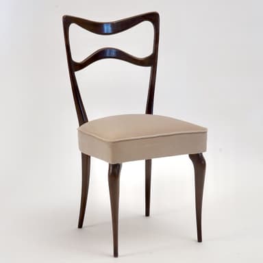A side chair with a curved, open backrest and a padded seat. The frame and legs are made of dark wood, with a sculpted, organic form. The seat is upholstered in a light-colored fabric. — 3D model