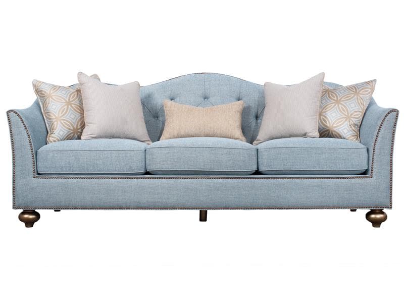 A light blue, three-cushion sofa featuring a gently curved back, rolled arms, and prominent nailhead trim detailing along the arms, base, and back. It comes with several accent pillows in complementary patterns and colors. The sofa rests on low, ornate, turned wooden legs with a metallic finish. — 3D model