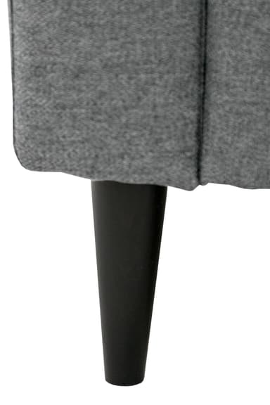 A close-up view of a grey upholstered furniture piece, featuring a vertically ribbed or seamed textile surface and a single black, tapered leg visible below. The fabric appears to be a textured, possibly woven, material, indicating a modern or contemporary design. — 3D model