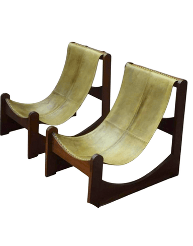 A modern sling-style lounge chair featuring a dark wood frame and a tan leather seat/back. The leather is stretched across the frame, forming a comfortable, reclined seating surface with visible stitching. — 3D model