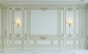 A decorative wall panel designed for interior decoration. It features ornate relief carvings, including floral and scroll motifs, with recessed rectangular panels. Two integrated wall sconces with white shades and gold-toned fixtures are mounted on the panel. The panel has a layered appearance with a primary off-white or cream color and gilded accents. — 3D model