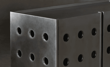 A modern cabinet with a brushed metal finish, featuring a series of circular cutouts on its visible face. The design is minimalist and geometric, suggesting a contemporary or industrial aesthetic. The surface exhibits a brushed texture, and the circular openings appear to be evenly spaced. — 3D model