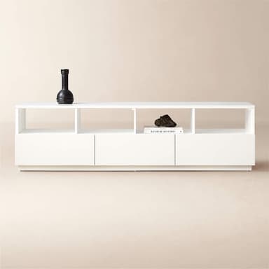 A modern, minimalist white nightstand featuring a clean, rectangular form and a recessed plinth base. It appears to have integrated storage on one side. — 3D model
