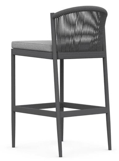 A contemporary bar stool featuring a dark grey aluminum frame, a backrest crafted from tightly woven dark grey rope, and a light grey upholstered seat cushion. It includes an integrated footrest. — 3D model