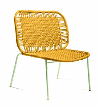 A contemporary low-profile accent chair featuring a seat and backrest constructed from a tightly woven synthetic cord in a mustard yellow hue. The chair sits on four slender, round tubular metal legs finished in a light mint green color. The overall design emphasizes a casual, modern aesthetic with rounded edges on the seat and back frame. — 3D model