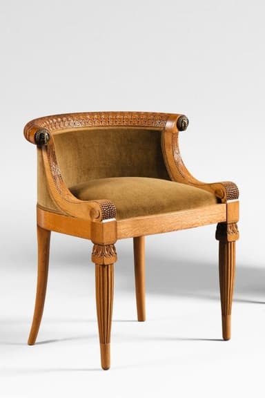 An antique armchair with a carved wooden frame and upholstered seat and back. The frame features fluted legs and ornate carvings along the top edge and arms. The upholstery is a textured, olive-green fabric. — 3D model