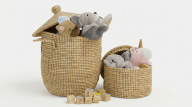 Two woven storage baskets of differing sizes, filled with plush toys and surrounded by wooden building blocks. The larger, taller basket features a fitted, domed lid and integrated handles, while the smaller basket is open-topped. Both baskets are constructed from a natural-colored woven fiber with a distinct crisscross pattern, appearing to be in excellent condition. — 3D model