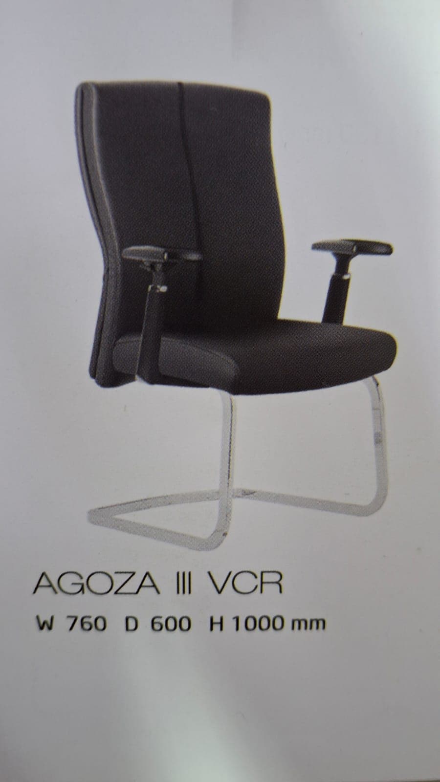 A contemporary office visitor chair featuring a high back, padded seat, and fixed loop armrests. The chair is upholstered in dark grey fabric and supported by a polished chrome-plated cantilever tubular steel frame. — 3D model