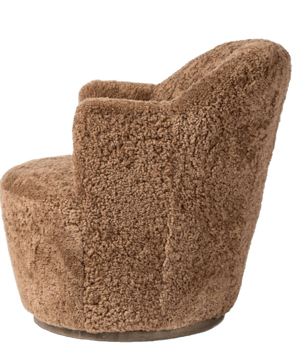 A plush, upholstered armchair with a rounded silhouette. The chair features a barrel-shaped base and a high, enveloping backrest that curves into armrests. The upholstery has a textured, shaggy appearance, resembling sheepskin or a similar natural fiber. — 3D model