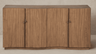 A long, low wooden cabinet featuring a serpentine or wave-like curved front. It has multiple doors, each adorned with a distinctive brass pull handle. The wood displays a natural grain pattern. — 3D model