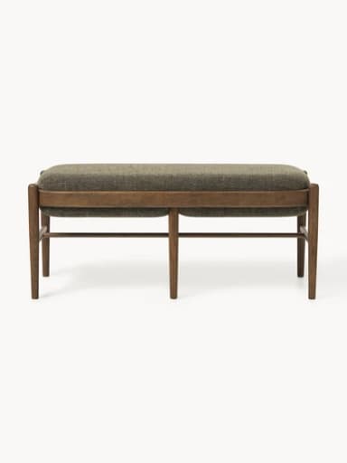 A rectangular upholstered ottoman featuring a solid wooden frame with rounded edges and four tapered legs. The top is generously padded and covered in a textured, greenish-brown fabric, while horizontal wooden stretchers provide structural support. — 3D model