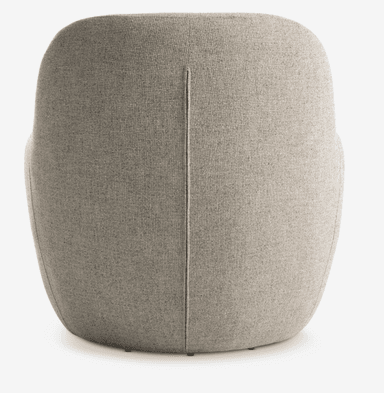 The image displays the back view of a contemporary upholstered barrel armchair. It features a continuous, rounded silhouette with a distinct vertical seam running down the center of the backrest. The chair is covered in a light beige or greige textured woven fabric. The design appears compact and minimalist, with a smoothly curved form that suggests an enveloping, comfortable seat. Small glides or feet are barely visible at the very bottom edge. — 3D model