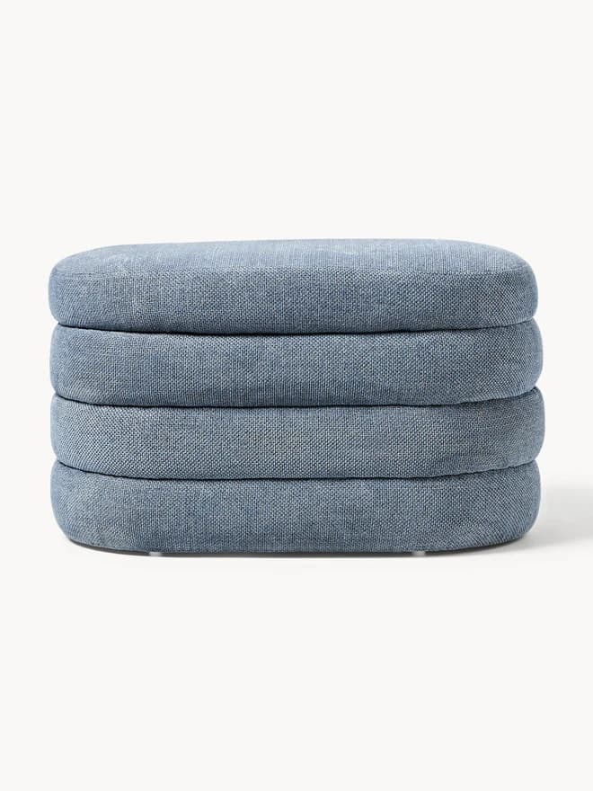 A stack of four upholstered ottomans, each with a rounded rectangular shape and a textile covering. The ottomans appear to be designed for stacking or as individual seating units. — 3D model