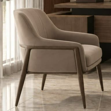 A modern upholstered accent armchair featuring a minimalist design. The chair has a comfortable, well-padded seat, backrest, and arms, all covered in a smooth, light beige or taupe fabric. The backrest is subtly adorned with vertical stitching, adding a refined detail. A dark wood frame is exposed along the outer edges of the arms and forms the sturdy, tapered legs, providing a contemporary contrast to the upholstery. — 3D model